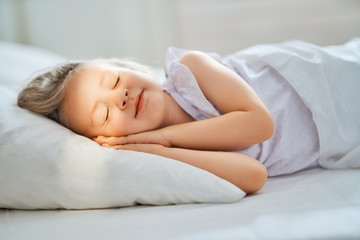 child is sleeping in the bed