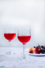 Pink wine. Wine in a glass near fruits and grapes. Traditional Georgian wine according to ancient technology. Copy space Close up and vertical orientation.