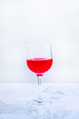 Pink wine. Wine in a glass near fruits and grapes. Traditional Georgian wine according to ancient technology. Copy space Close up and vertical orientation.