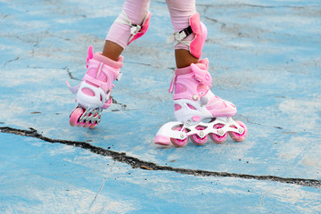 Legs of girls playing Roller Blade Skate or In-line Skate on cement floors.