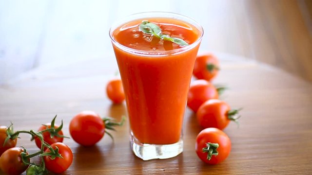 homemade tomato juice in a glass and fresh tomatoes