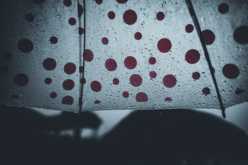 Water droplets on the glass And umbrellas