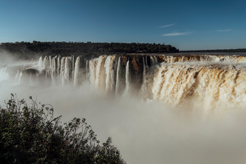 Gigantic, huge, waterfall. Garganta del diablo waterfall, in Iguazu Falls, at sunset. Violent watercourse, millions of gallons of water per second. Impressive jump. Province of Misiones, Argentina..