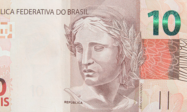 Brazilian ten real banknote. Red note, 10 reais brl. Brazilian money, real note. Macro photo.