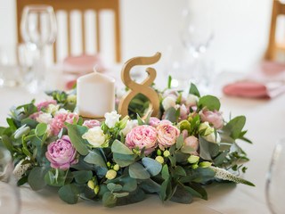 Wedding table decorations with flowers, candles and numbers