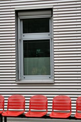 Fototapeta premium red chairs for metallic wall, background, 