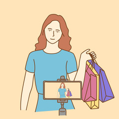 Camera recording a young female blogger shopping while making a video