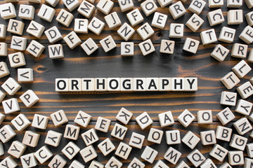orthography - word from wooden blocks with letters, *** concept, random letters around, white  background