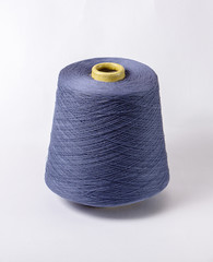 bobbin of yarn on a white background. Side view.Textile reel on isolated white background.