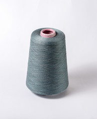 bobbin of yarn on a white background. Side view.Textile reel on isolated white background.