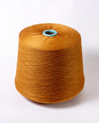 bobbin of yarn on a white background. Side view.Textile reel on isolated white background.