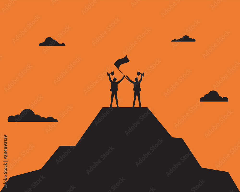 Wall mural businessman holding up a gold trophy cup with success flag on top of mountain