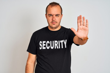 Young safeguard man wearing security uniform standing over isolated white background with open hand...