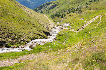 Fototapeta na wymiar Beautiful views of the mountain meadows and mountain river, view from Grossglockner High Alpine Road, Austria