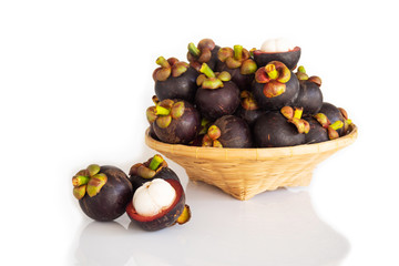 Fresh mangosteen in bamboo basket on white isolate background. Healthy and sweet fruit. High vitamins.