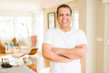 Middle age man smiling confident to the camera at home