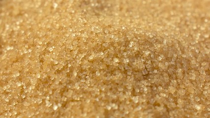 Brown sugar sprinkle on top. Close-up. Cane sugar unrefined, dry demerara. Saccharose