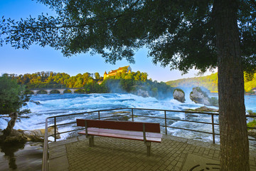 Early in the morning at sunrise, a few hours before onslaught of tourists, at the Rhine Falls, near the city of Schaffhausen,, more precisely in Neuhausen, Switzerland. Summer 2019, month of August.