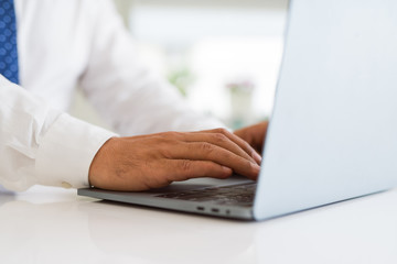 Close up of business man working using computer laptop