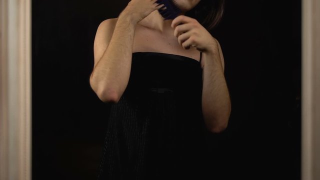 Male transgender model combing wig, happy and proud to realize homosexuality