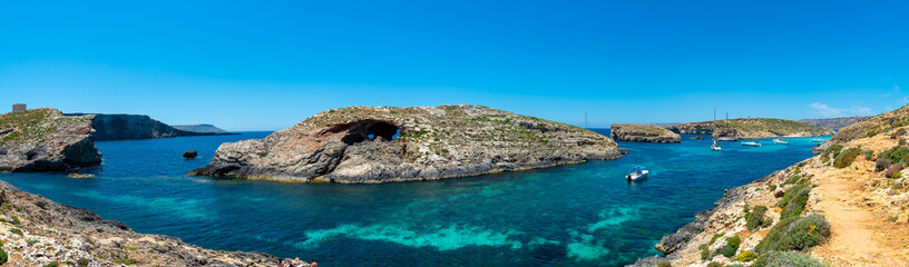 Fototapeta premium Stone cliffs on the blue lagoon of the island of Comino and Gozo Malta. Mediterranean Sea