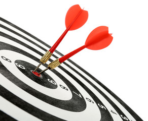 Arrows hitting target on dart board against white background