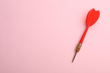 Red dart arrow on pink background, top view with space for text