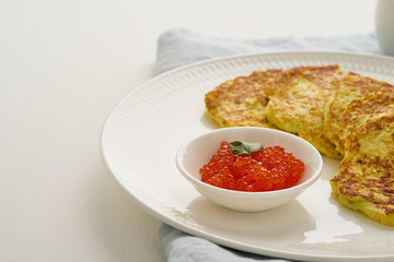 Zucchini pancakes with potato and red caviar, fodmap keto diet side view closeup