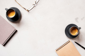 Office background with two cups of coffee espresso and open notepads