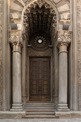 Beautiful old building with arch and ornate door