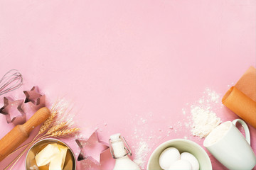 Pink background with raw ingredients for baking, traditional cookies or cakes