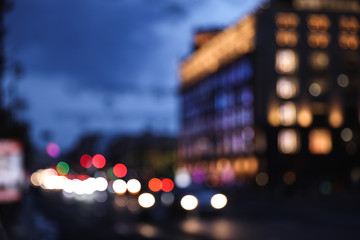 Fototapeta na wymiar Blurred view of modern city at evening. Bokeh effect