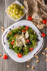 salad provence with blue cheese on wooden table
