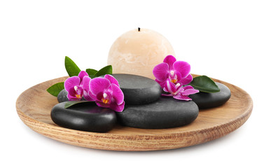 Wooden tray with spa stones, orchid flowers and candle on white background