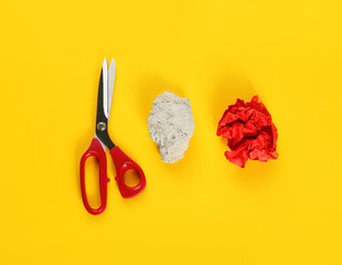 Flat lay composition with rock, paper and scissors on yellow background