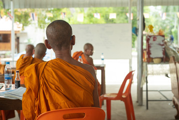 Back portrait of  monk sits in the class at the temple