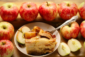 pieces of fresh baked apple pie among raw apples country style still life