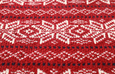 Warm Christmas sweater with snowflakes as background, closeup