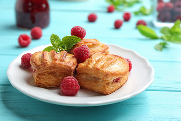 Fresh delicious puff pastry with sweet berries served on light blue wooden table
