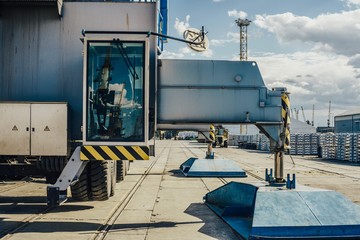 Cargo at the port. Aluminum ingots on the pier. Against the background of cargo depots and ships
