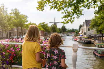 Rear view of two little girls looking at view on bridge, Dokkum, Holland