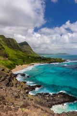 A view of Makapu'u beach, on the east side of Oahu, Hawaii.  The day is sunny and the sky is blue