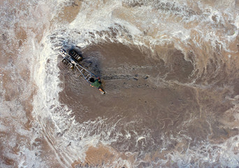 Asian farmer plow for rice plant in rainy season, rural countryside of Thailand.