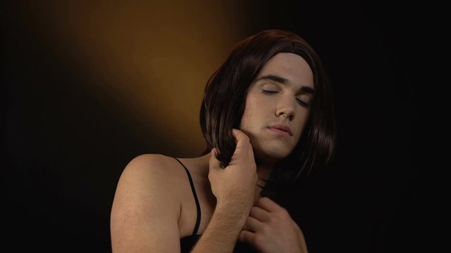 Happy male trans taking estrogen pills, transgender feminizing hormone therapy