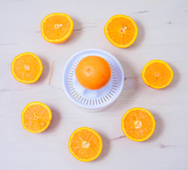 Fresh oranges with juicer pressed manual method.