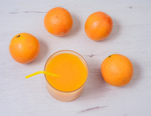 Healthy fresh juice, juicer and oranges on the kitchen table