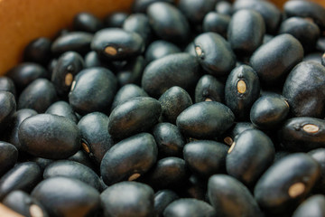 A cup of black beans  with assorted beans blurred background 
