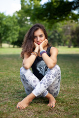 Fototapeta premium Young sexy brunette woman relaxing in the park