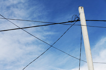 Electricity power pole with many wires and blue sky