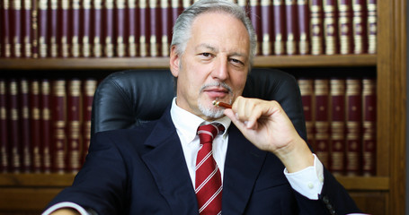 Portrait of smiling senior businessman in his library